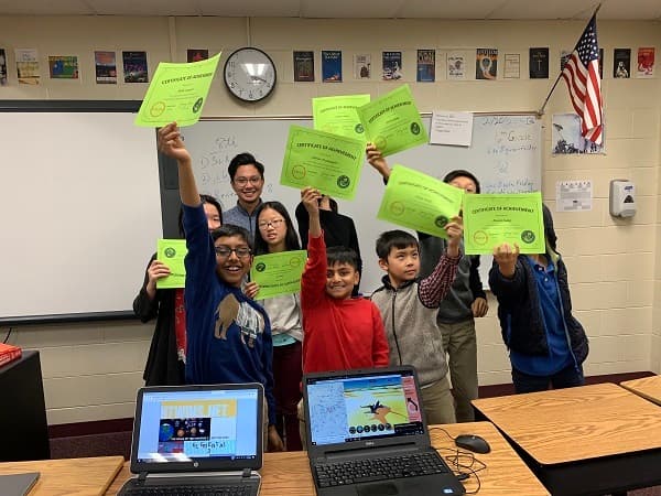 Students holding certificates
